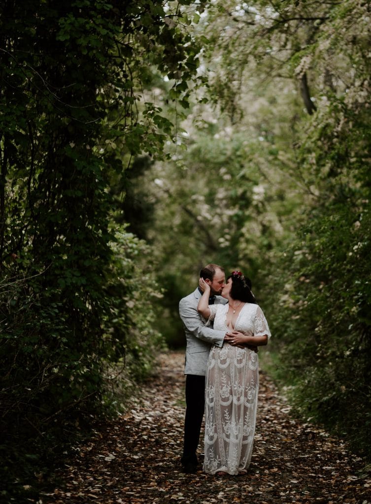 Couple kissing in the forest at their Small Wedding Elopement. Niagara wedding photographer.