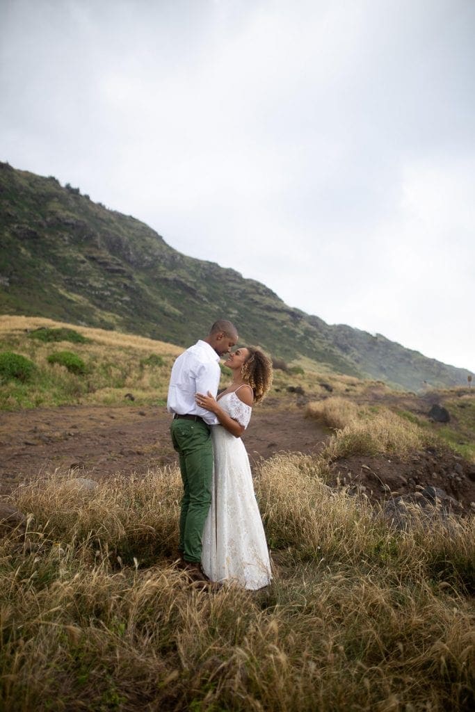 a couple on their wedding day kissing in the mountains. destination wedding photographer.