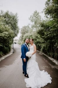 A bride and groom standing in a pathway looking at the camera at whistle bear golf club. Kitchener wedding photographer.