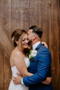 a groom whispering to his bride making her laugh. Kitchener wedding photographer